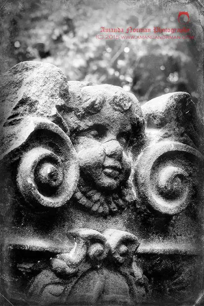 Photograph of a baby face on a headstone